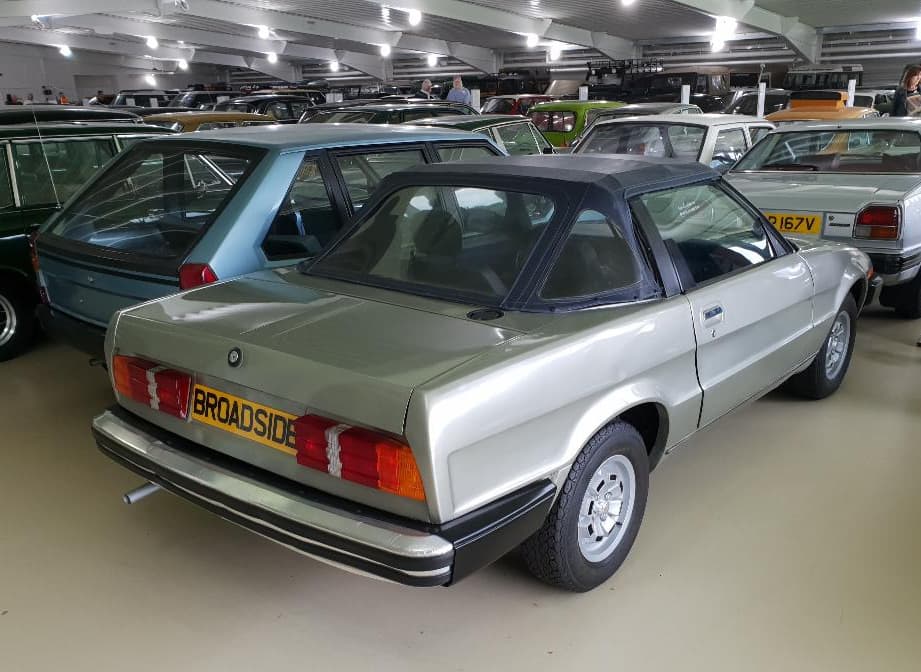 The tail of a silver prototype coupé with BROADSIDE on its number plate. Opens a larger view