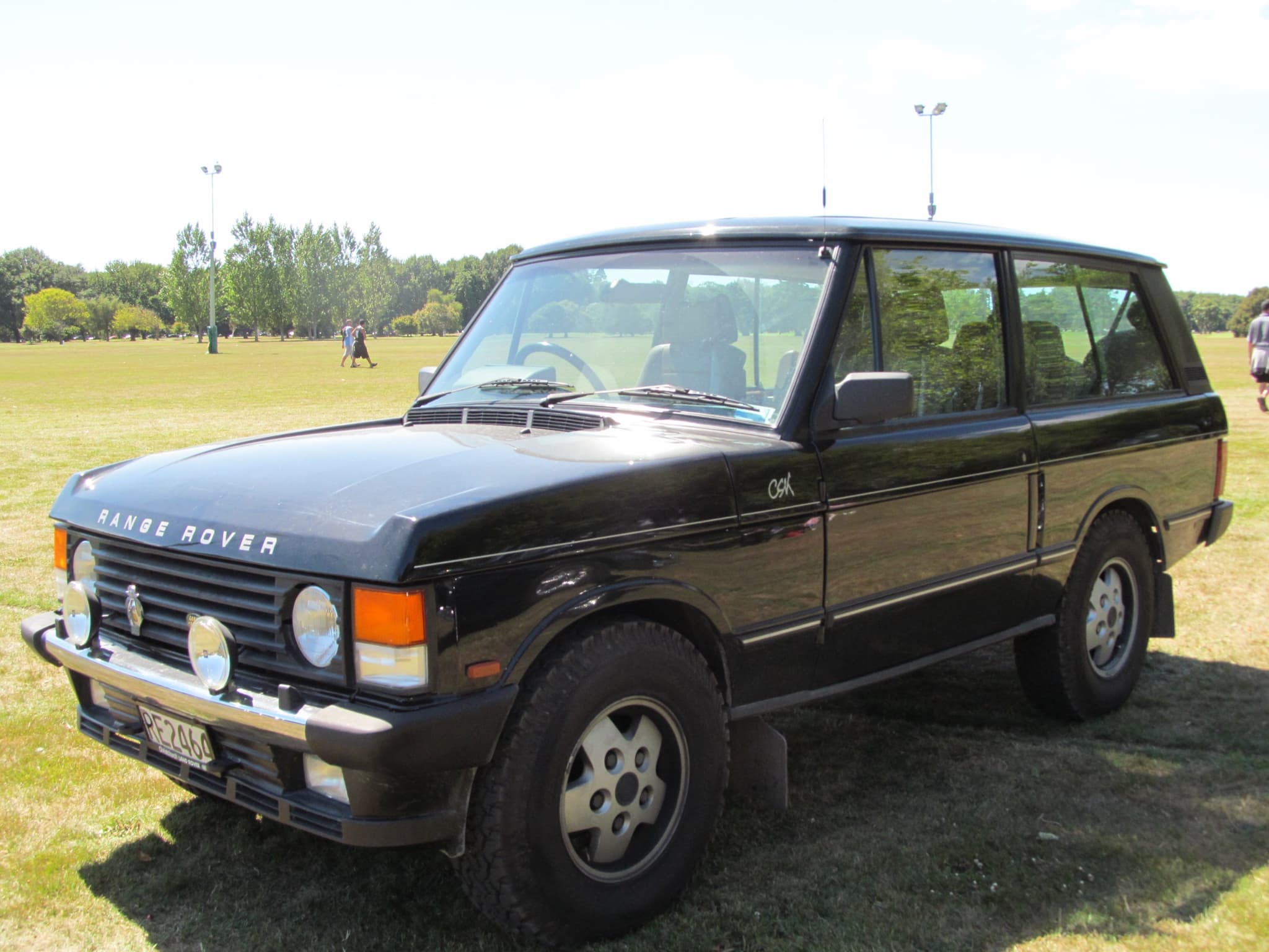 A dark two-door Range Rover with CSK badging, parked outdoors.