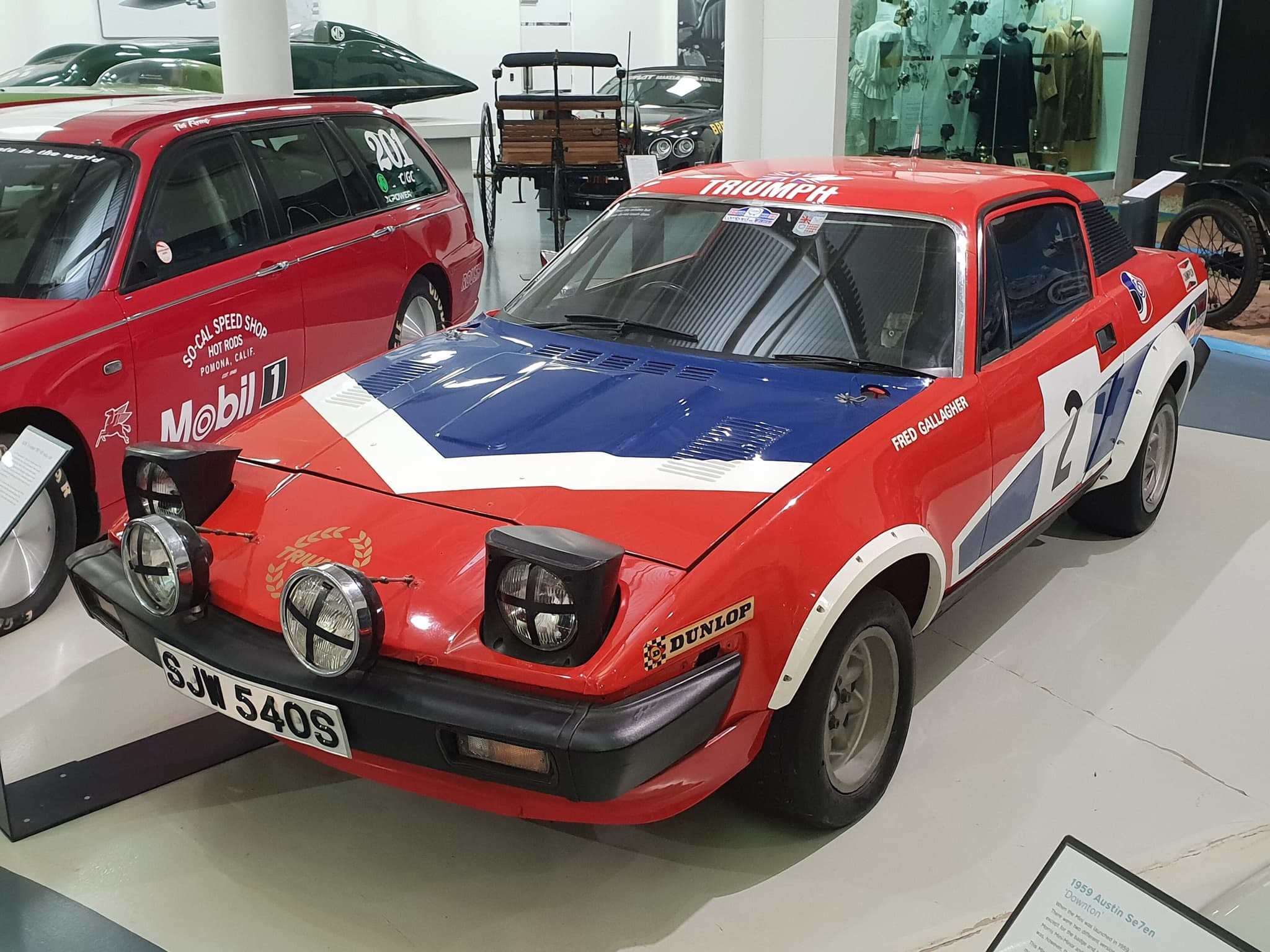 SJW 540S in its red, white and blue, seen from the front three-quarter in a museum hall.